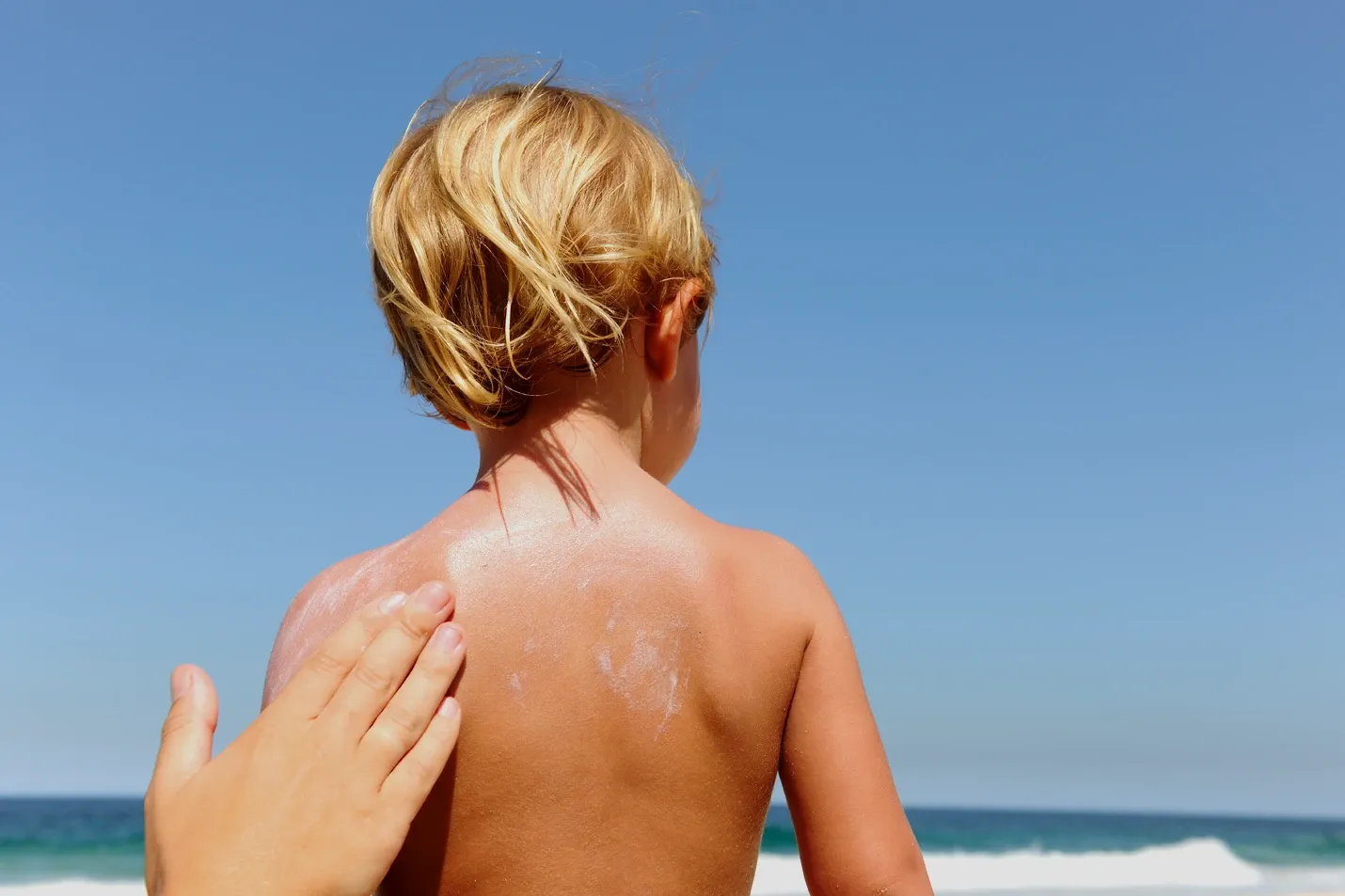 a child with sunblock on his back